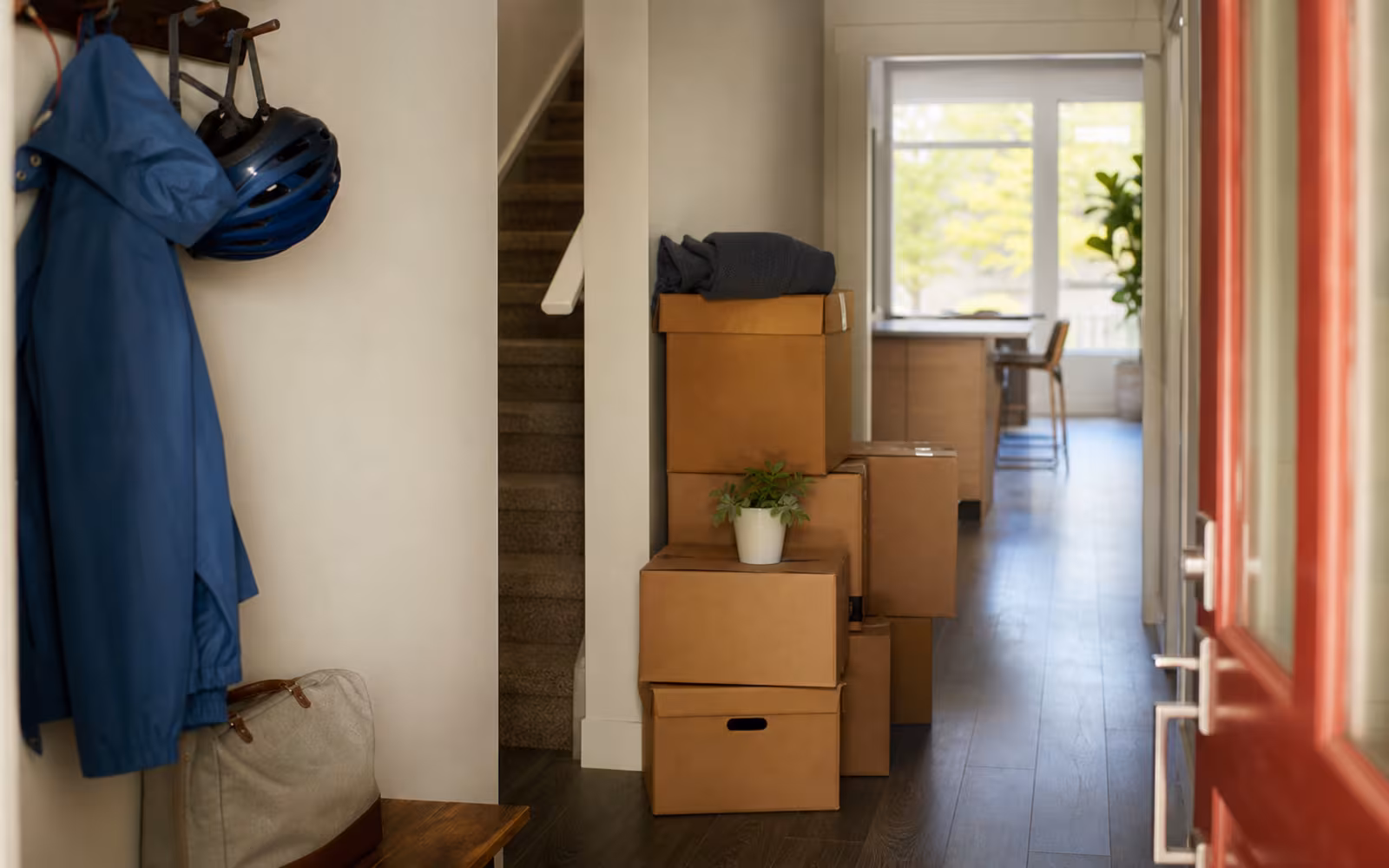 Canadian townhouse entry with moving boxes and rain gear representing a short timeline where an open mortgage may fit.